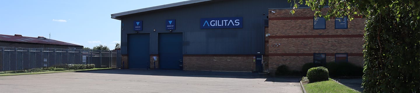 Photo of Agilitas HQ, sunny day, with large warehouse
